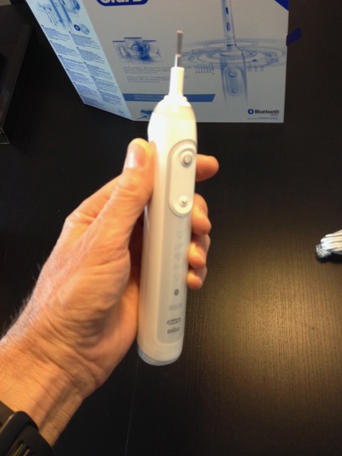Holding an oral B genius toothbrush in my left hand