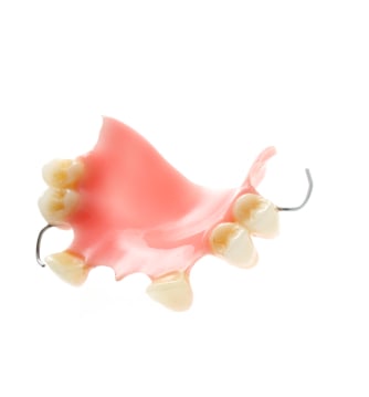An upper partial acrylic denture against a white background.