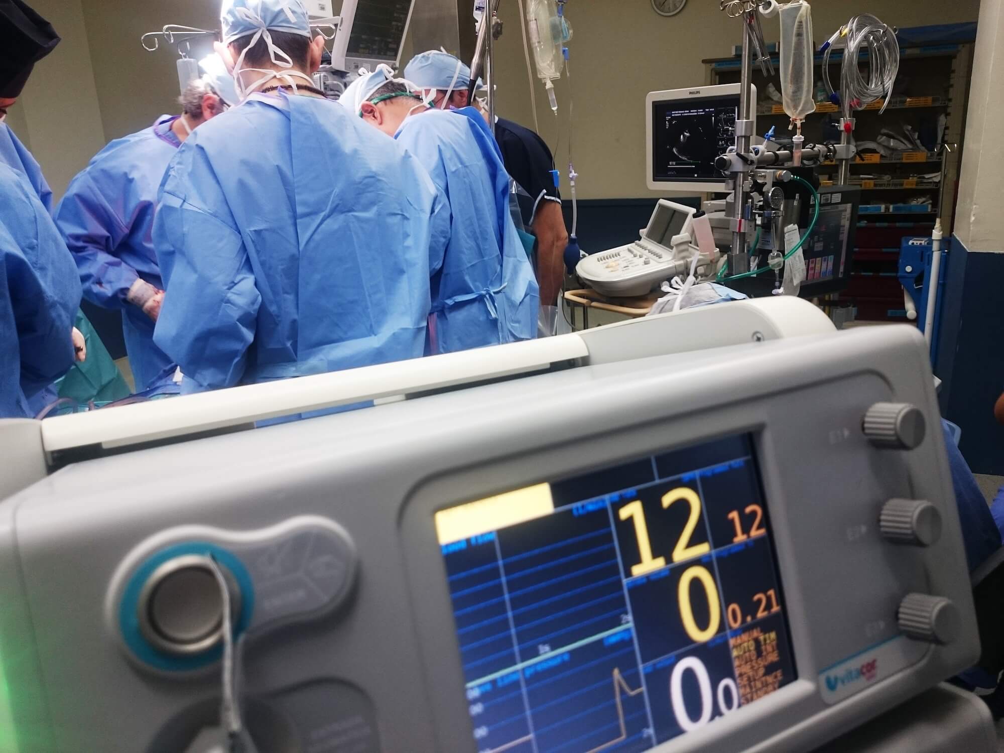 surgeons in blue scrubs in an operating theater surgeons in blue scrubs in an operating theater