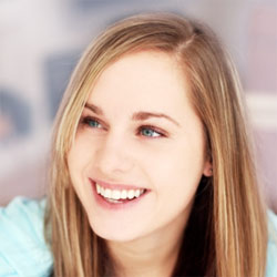 A young woman with white teeth and brown hair, smiling. A young woman with white teeth and brown hair, smiling.